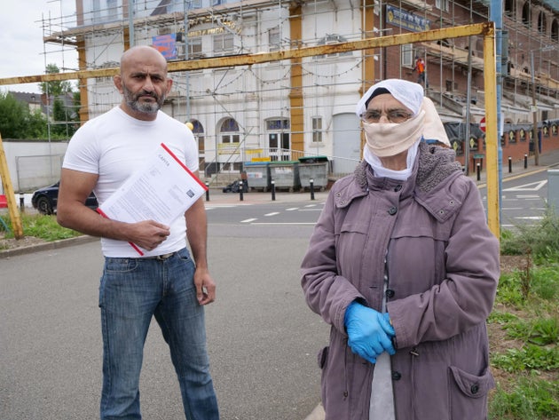 Salman Mirza, her caseworker, standing next to Gurmit Kaur.