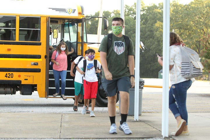 Students wearing masks head to class at Mooreville High School in Mooreville, Mississippi, on Thursday. The high school is not part of the Corinth School District, where seven coronavirus cases were confirmed. 