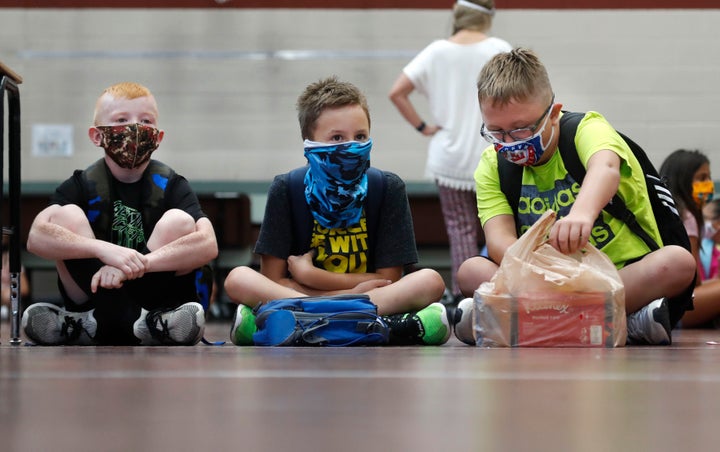 Elementary school students wait for classes to begin in Godley, Texas, on Wednesday. States in the South and Southwest have recently seen the highest number of new coronavirus cases per capita.