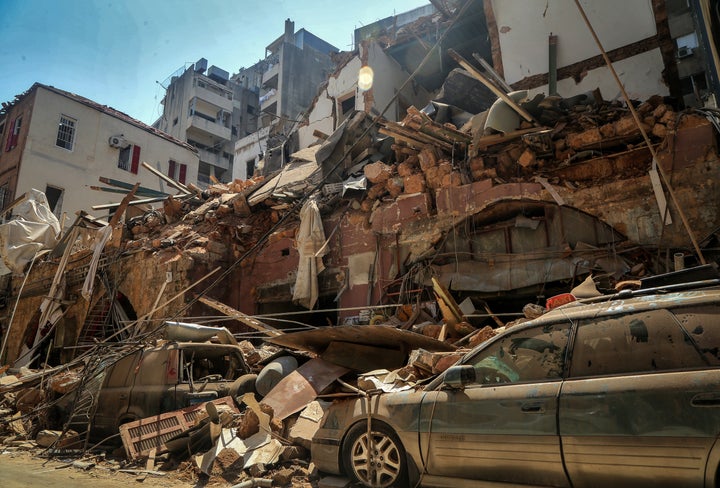 Cars under the rubble of a destroyed house a day after a massive explosion in Beirut's port, killing at least 100 people and injured thousands.