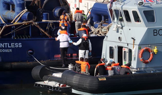 A Border Force vessel brings a group of men thought to be migrants into Dover, Kent.