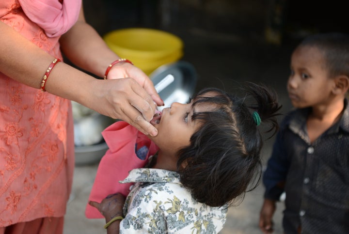 An child receives polio drops from a health worker during a polio immunisation programme in Siliguri on January 30, 2017. 