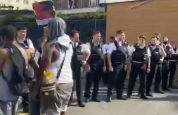 Police officers and young people outside Colindale Police Station on Friday afternoon. Picture: Temi Mwale