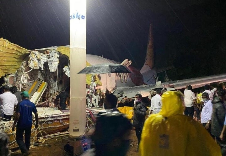 Teams conduct search and rescue operation at the site after an Air India Express passenger plane with 190 passengers onboard skidded off the runway in Kerala on August 7, 2020. 