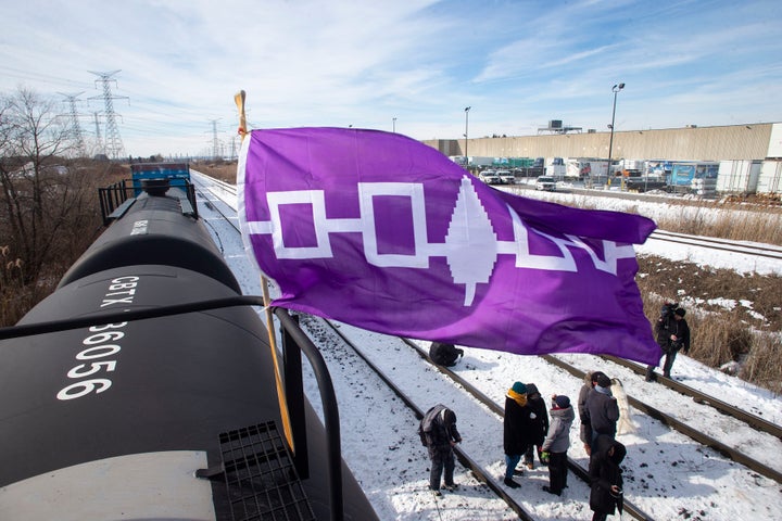 A Haudenosaunee flag, representing the First Nations people also known as the Iroquois or Six Nations, flies from a petroleum car during the blockade of the rail line at Macmillan Yard in Toronto on Feb. 15, 2020. 