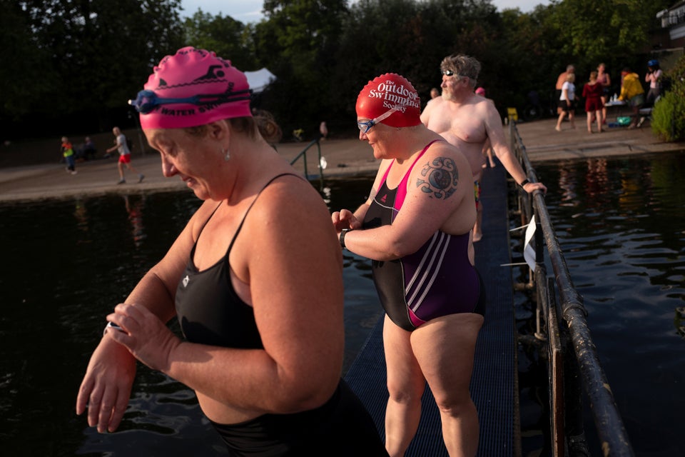 People enjoy the sunny weather at The Serpentine in Hyde Park.