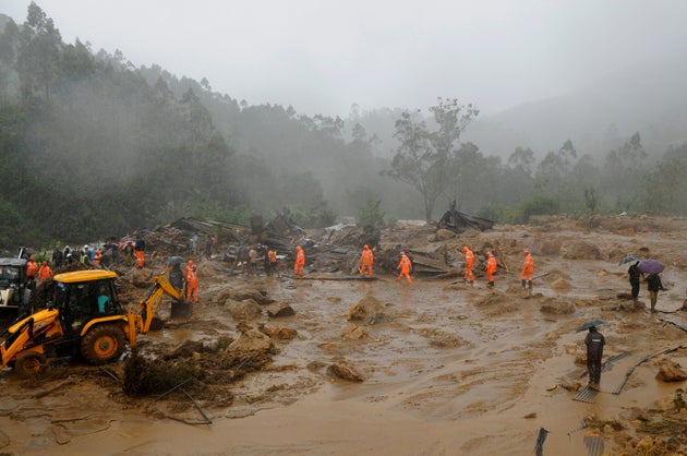 Rescuers work at the site of a mudslide triggered by heavy monsoon rain in Idukki, Kerala, Aug. 7,