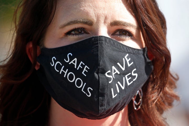 Utah school teacher Emily Johnson protests with other teachers at the Utah State Capitol, Friday, Aug. 7, 2020, in Salt Lake City. (AP Photo/Rick Bowmer)