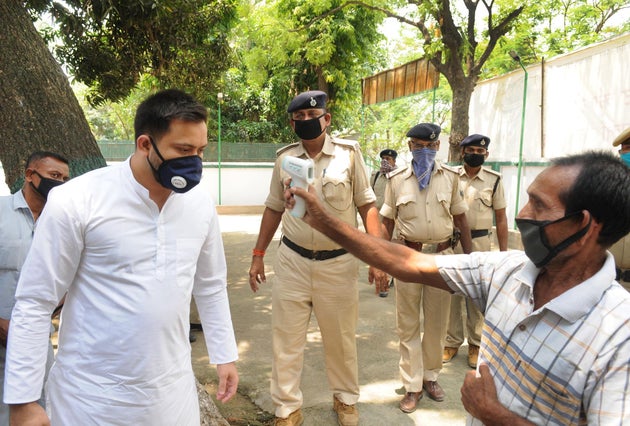 RJD leader and leader of opposition in Bihar assembly Tejashwi Yadav undergoes thermal screening before...