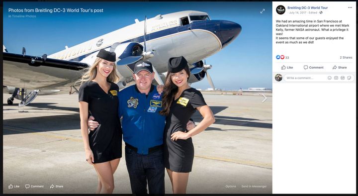 Democratic Senate candidate Mark Kelly poses with models at a Breitling event.