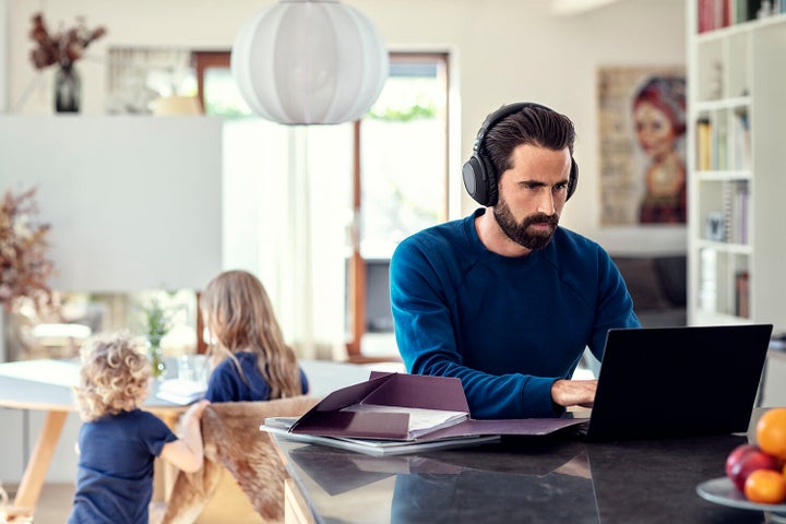 Man working from home - listening to headphones