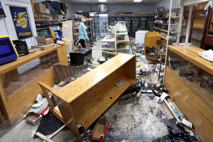 Kajal Dalal walks through her family's food and liquor store in downtown Chicago on Monday after it was vandalized. 