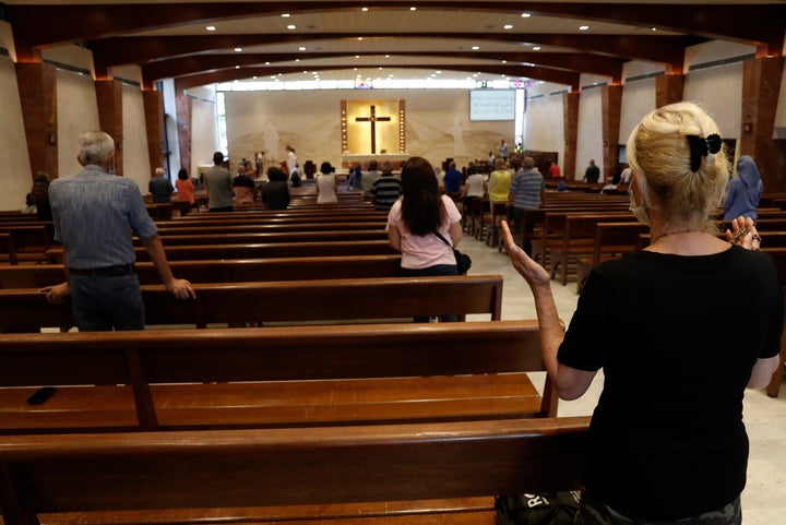 People pray as they attend a Sunday Mass at Saint Maron-Baouchrieh Church in Beirut's Baouchrieh neighborhood on Sunday, Aug.