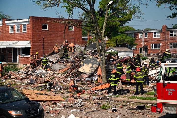 Firefighters search what remains of homes that were destroyed in a gas explosion Monday at Boxhill Road and Reisterstown Road in Northeast Baltimore.
