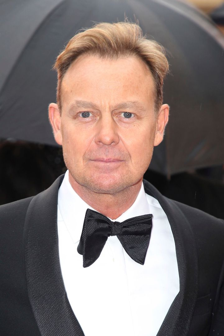Jason Donovan poses for photographers upon arrival at the Olivier Awards in London, Sunday, April 8, 2018. 