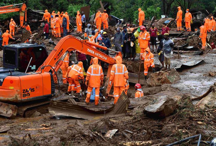 Rescue workers search for missing people at a landslide site caused by heavy rains in Pettimudy, in Kerala on August 8, 2020. 