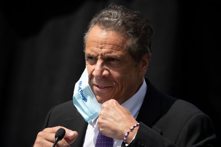 In this June 15, 2020, file photo, New York Gov. Andrew Cuomo removes a mask as he holds a news conference in Tarrytown, N.Y. (AP Photo/Mark Lennihan, File)