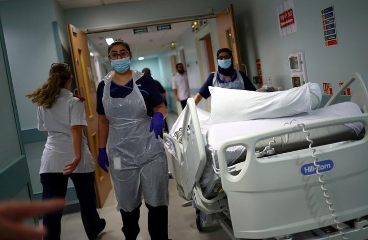 Medical staff transfer a patient through a corridor at the Royal Blackburn Teaching Hospital, in Blackburn, England, amid the coronavirus pandemic