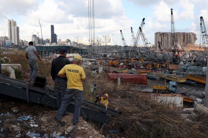 Workers remove debris from the site of last week's explosion that hit the seaport of Beirut, Lebanon, Monday, Aug. 10, 2020.