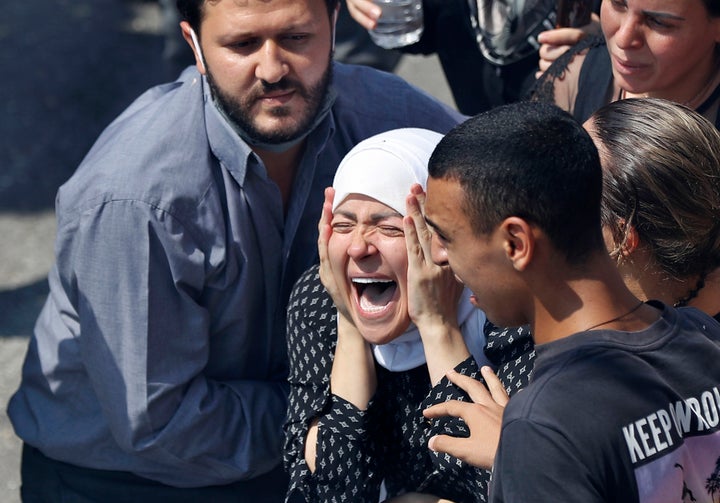 The wife of Rami Kaaki, one of ten firefighters who were killed during the last week's explosion that hit the seaport of Beirut, mourns during her husband's funeral at the firefighter headquarters, in Beirut, Lebanon, Tuesday, Aug. 11, 2020. (AP Photo/Hussein Malla)