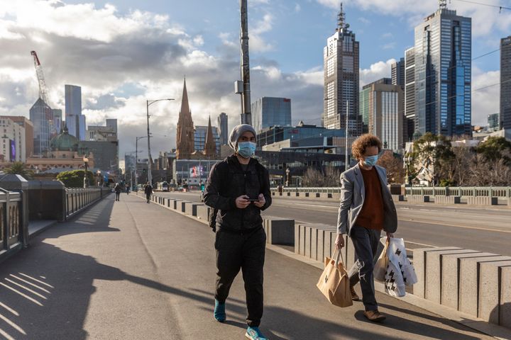 Pedestrians walk away from the central business district as lockdown due to the continuing spread of the coronavirus starts in Melbourne, Wednesday, Aug. 5, 2020. Victoria state, Australia's coronavirus hot spot, announced on Monday that businesses will be closed and scaled down in a bid to curb the spread of the virus. (AP Photo/Asanka Brendon Ratnayake)WLd