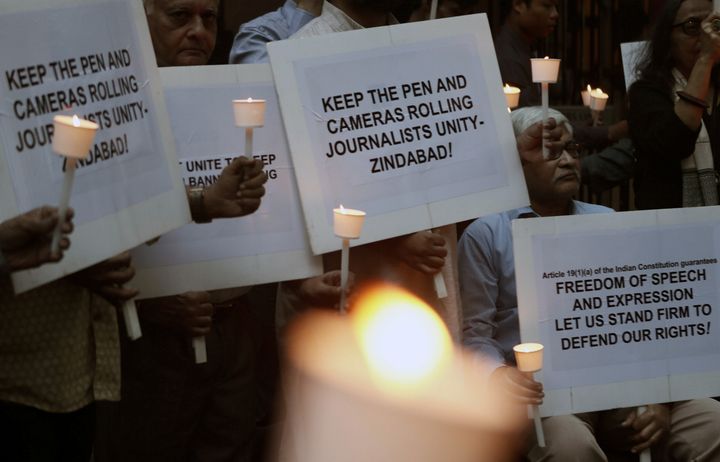Journalists hold candles and placards during a candlelight vigil against police brutalities and attacks on press freedom in Mumbai, India December 26, 2019. REUTERS/Francis Mascarenhas