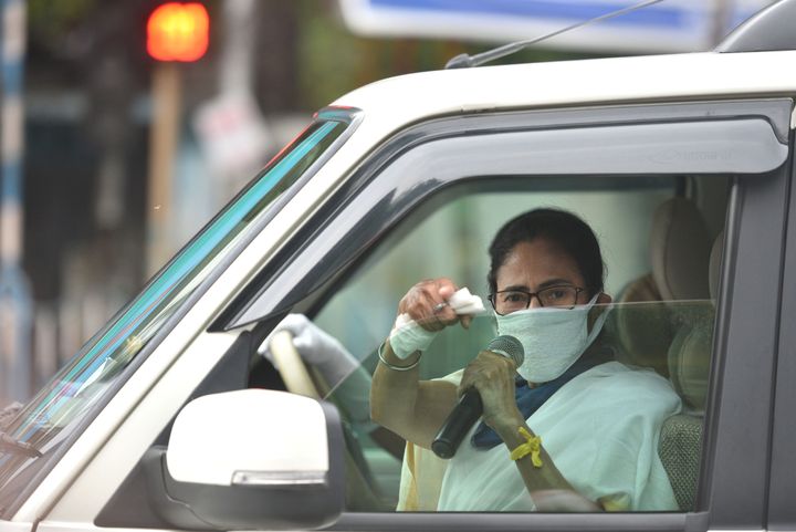 Chief minister of West Bengal Mamata Banerjee directs people for proper adherence of social distancing, during lockdown to curb the spread of coronavirus, at Moulali crossing in Kolkata on April 23, 2020. 