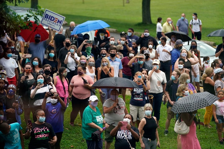 People stand outside before Democratic presidential candidate former Vice President Joe Biden and his running mate Sen. Kamala Harris (D-Calif.) appear at Alexis Dupont High School in Wilmington on Aug. 12.