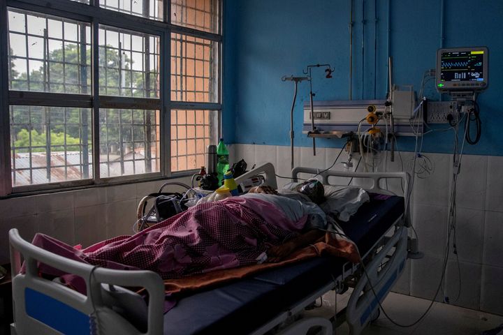 A COVID-19 patient lies on a hospital bed in the Intensive Care Unit of Jawahar Lal Nehru Medical College and Hospital in Bhagalpur, Bihar, India, July 26, 2020.