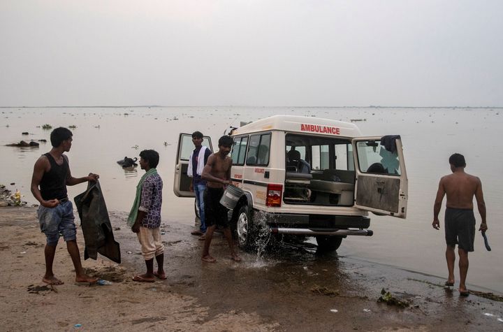 People wash an ambulance on the banks of River Ganga behind Jawahar Lal Nehru Medical College and Hospital, during the coronavirus disease (COVID-19) outbreak, in Bhagalpur, in the eastern state of Bihar, India, July 26, 2020.