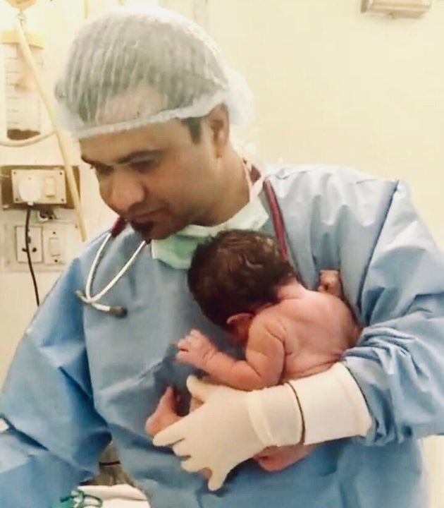 Dr Kafeel khan holding his son Oliver Kafeel