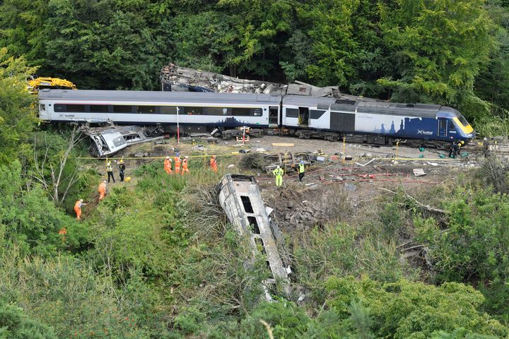 Emergency services inspect the scene following a train derailment near Stonehaven, Scotland