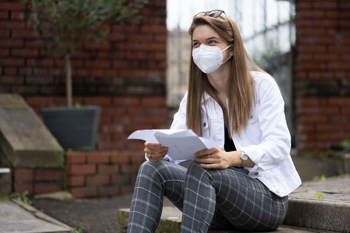 Emelia Ambrose wears a surgical mask while looking at her A Level results at Ffynone House School on August 13, 2020 in Swansea, Wales. 