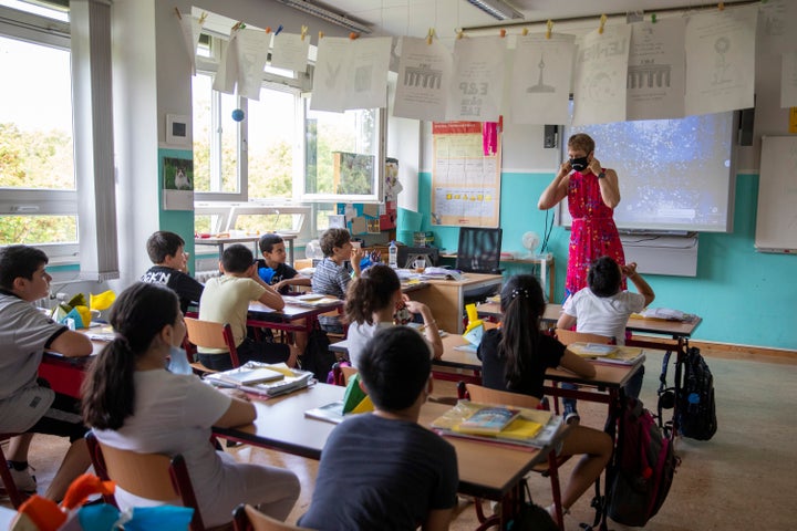 Children sit for the first day of classes of the new school year at the GuthsMuths elementary school in Berlin on August 10. Safety requirements in German schools include keeping windows open for ventilation.