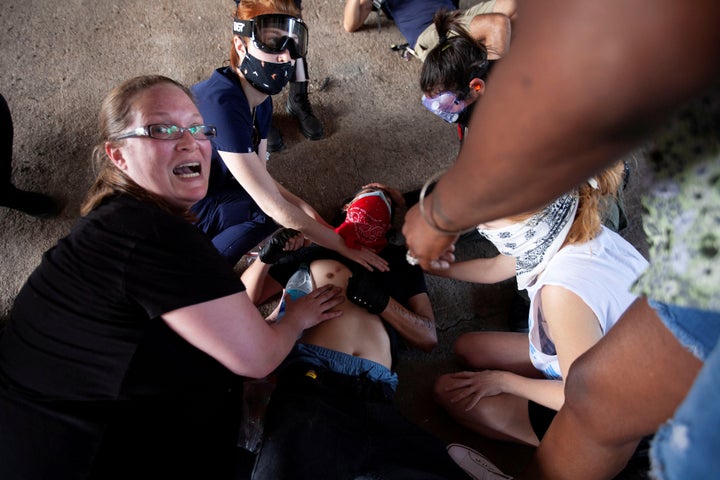 A protester, who was hit by an object fired by police, is aided by other protesters during a rally against the death in Minneapolis police custody of George Floyd, in Austin, May 30.