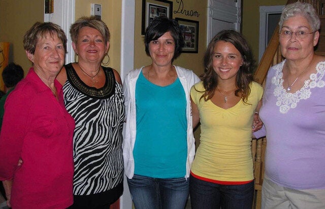 The writer, second from right, stands arm-in-arm with her biological mother, centre, in a meeting with the writer's adoptive family.