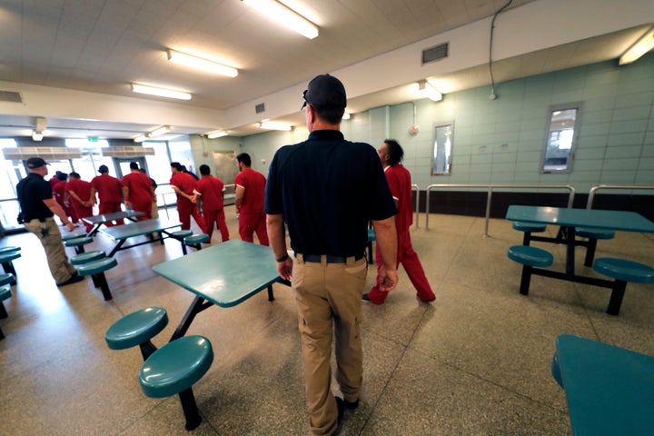 Detainees leave the cafeteria under the watch of guards during a media tour at the Winn Correctional Center in Winnfield, Louisiana, Sept. 26, 2019. (AP Photo/Gerald Herbert)