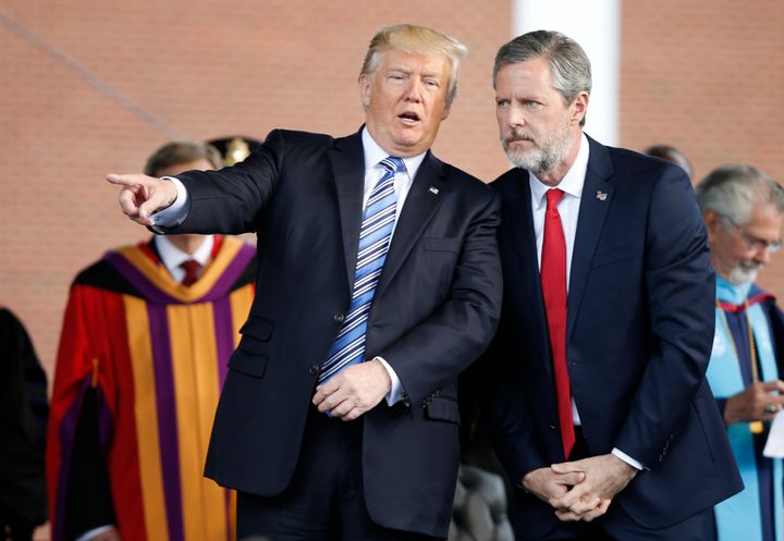 In this May 13, 2017 file photo, President Donald Trump gestures as he stands with Liberty University president, Jerry Falwell Jr., right, during commencement ceremonies at the school in Lynchburg, Va.