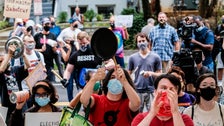 'Noise Demonstration' Held Outside Home Of U.S. Postmaster General