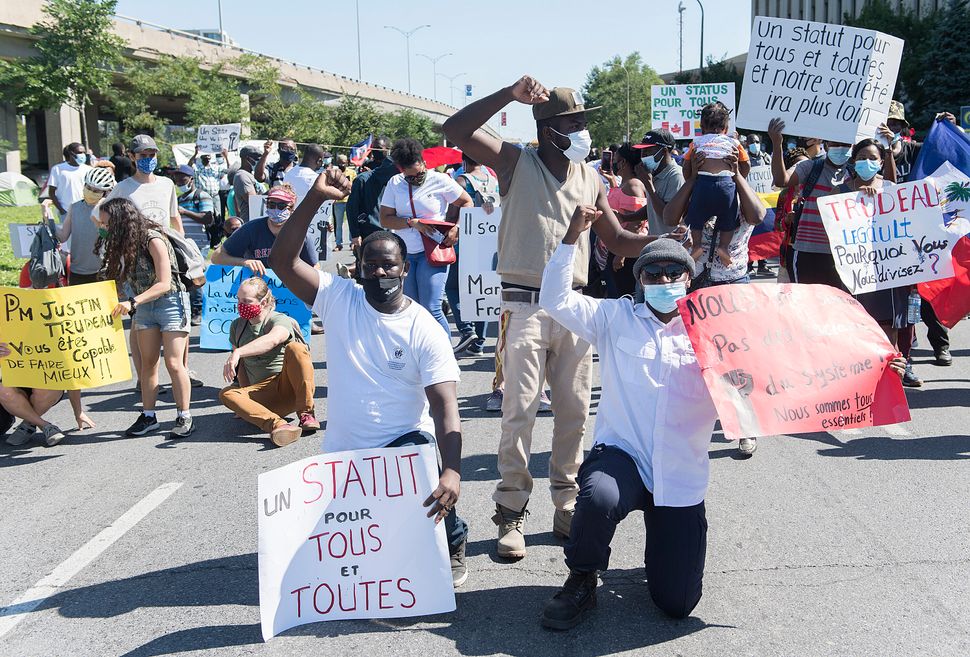 Protesters calling for the government to give residency to all migrant workers and asylum seekers gathered in front of Prime Minister Justin Trudeau’s constituency office in Montreal, on Aug. 1st.
