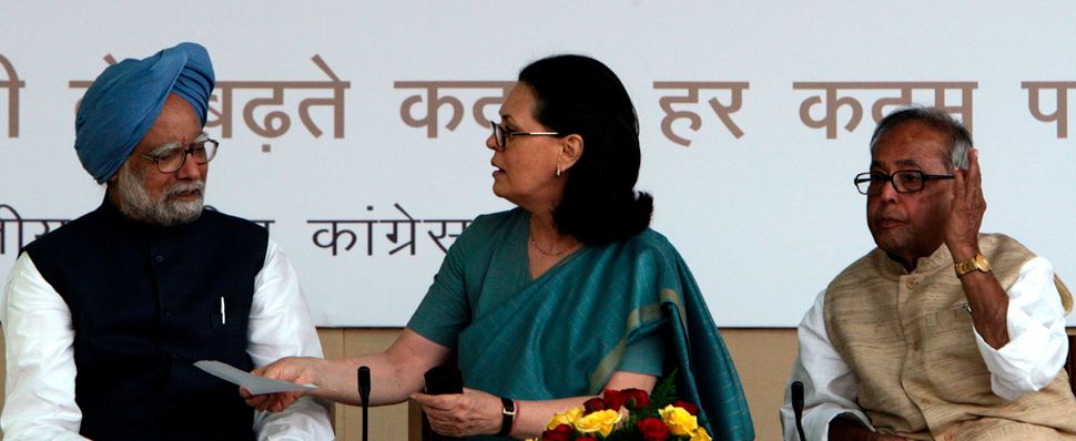 A 2009 photo of Sonia Gandhi speaking to then Prime Minister Manmohan Singh as Foreign Minister Mukherjee watches, during the release of the Congress manifesto.