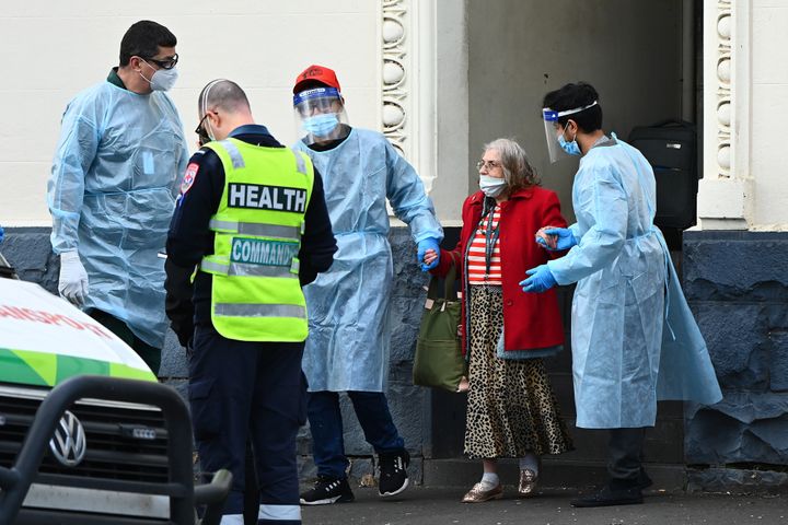 Residents of Hambleton House are put in Patient Transport vehicles on August 17, 2020 in Melbourne, Australia. Health authorities are investigating Hambleton House in Albert Park following a coronavirus outbreak among residents.
