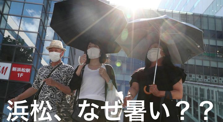 猛暑の中、日傘を差して歩く人たち＝8月16日午後、浜松市 