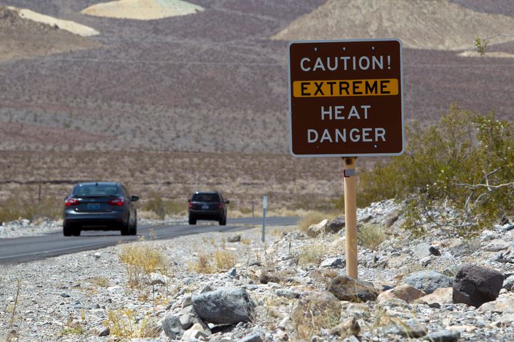 A sign warns of extreme heat as tourists enter Death Valley National Park in California June 29, 2013. The high temperature reached 128 degrees fahrenheit. REUTERS/Steve Marcus (UNITED STATES - Tags: SOCIETY TRAVEL ENVIRONMENT)