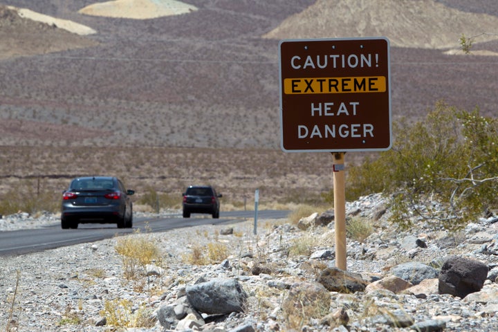 A sign warns of extreme heat as tourists enter Death Valley National Park in California June 29, 2013. The high temperature reached 128 degrees fahrenheit. REUTERS/Steve Marcus (UNITED STATES - Tags: SOCIETY TRAVEL ENVIRONMENT)