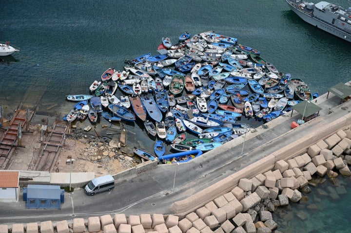 Boats used by migrants sit abandoned near the port at Lampedusa, Italy, on Aug. 4.