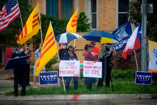 Protesters hold up signs and flags outside of the Chinese consulate in Houston, Texas, on July 24, 2020,...