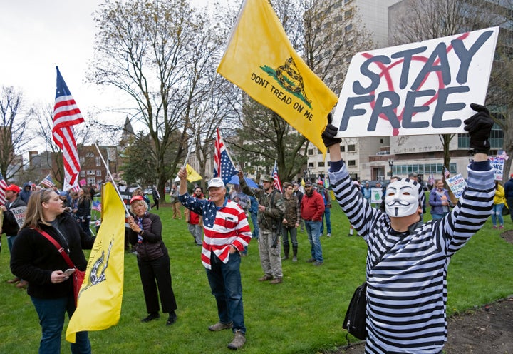 In the United States, protesters rally against lockdown restrictions outside of the capitol building in Lansing, Michigan, April 30.