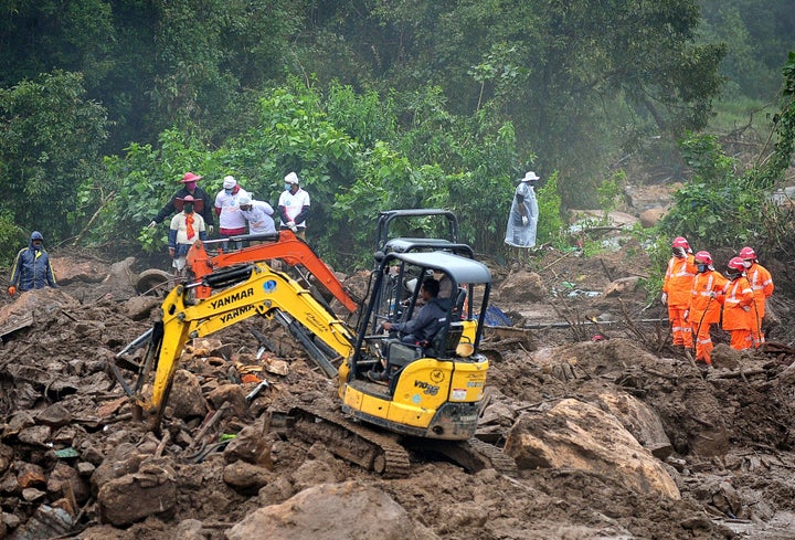 A 10 August 2020 photo of rescue workers searching for missing people at the landslide site in Pettimudi. 61 bodies have been recovered so far, while 9 people are still missing. 