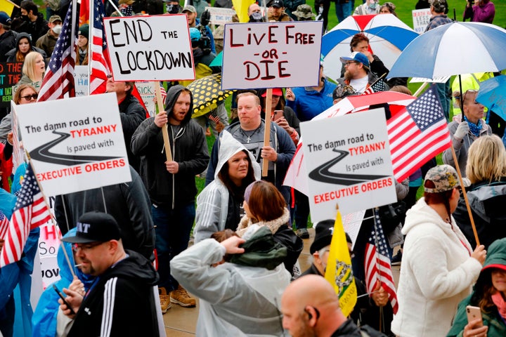 Demonstrators protest coronavirus-related health guidelines outside the Michigan Capitol on April 30, 2020, without wearing masks or social distancing.
